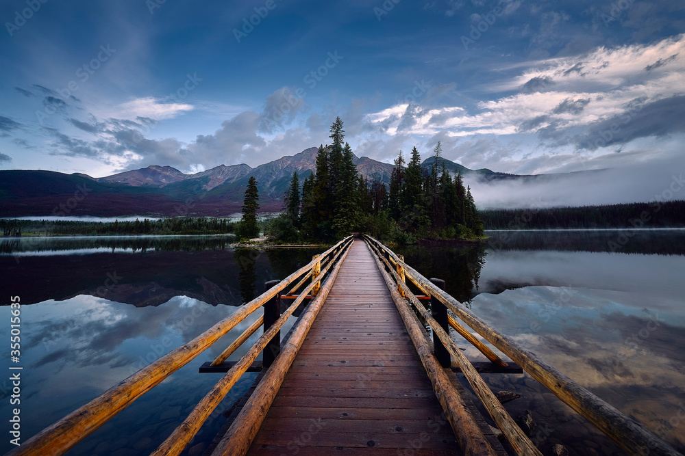 Rustic wooden walkway leading to Pyramid Lake Island Canada