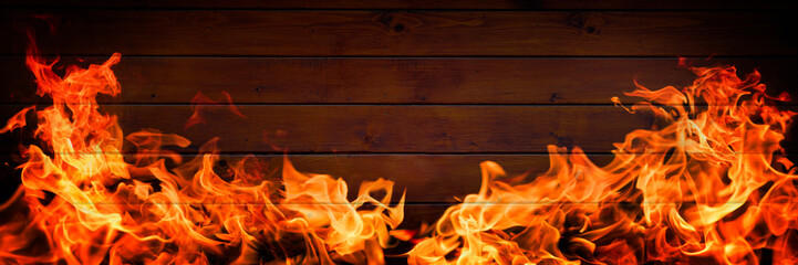 Fire flames on wooden background, barbecue grill copy space