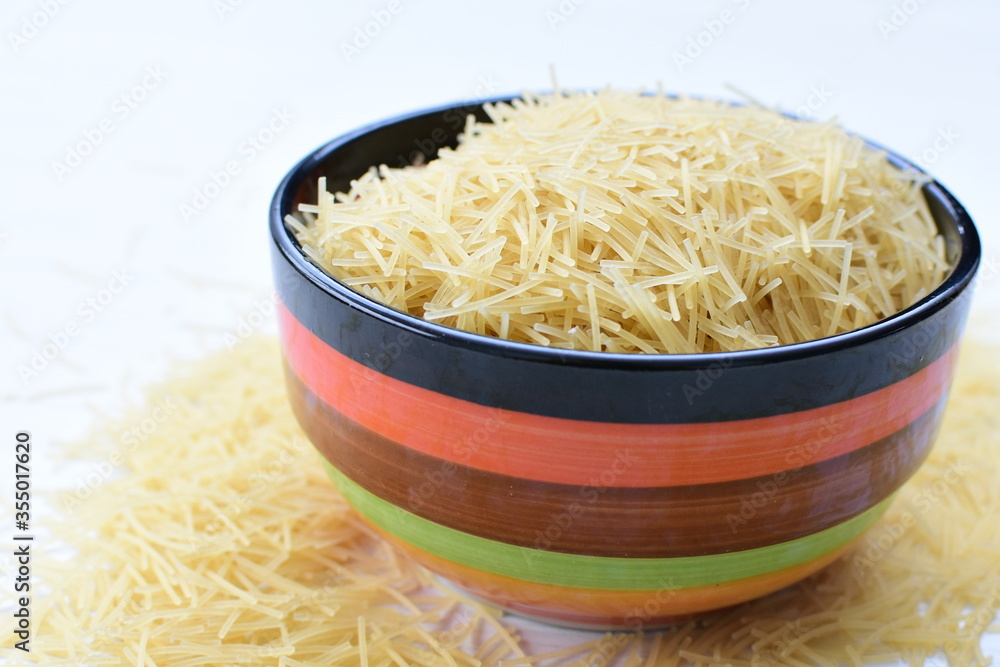 Short pasta spaghetti angel hair displayed in containers on white background Short pasta spaghetti angel hair displayed in containers on white background
