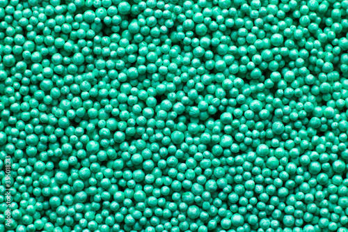 Green plasticine of the smallest foam balls as background and texture