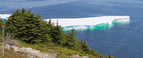 Iceberg floating off the coast near Twillingate, Newfoundland, Canada photo