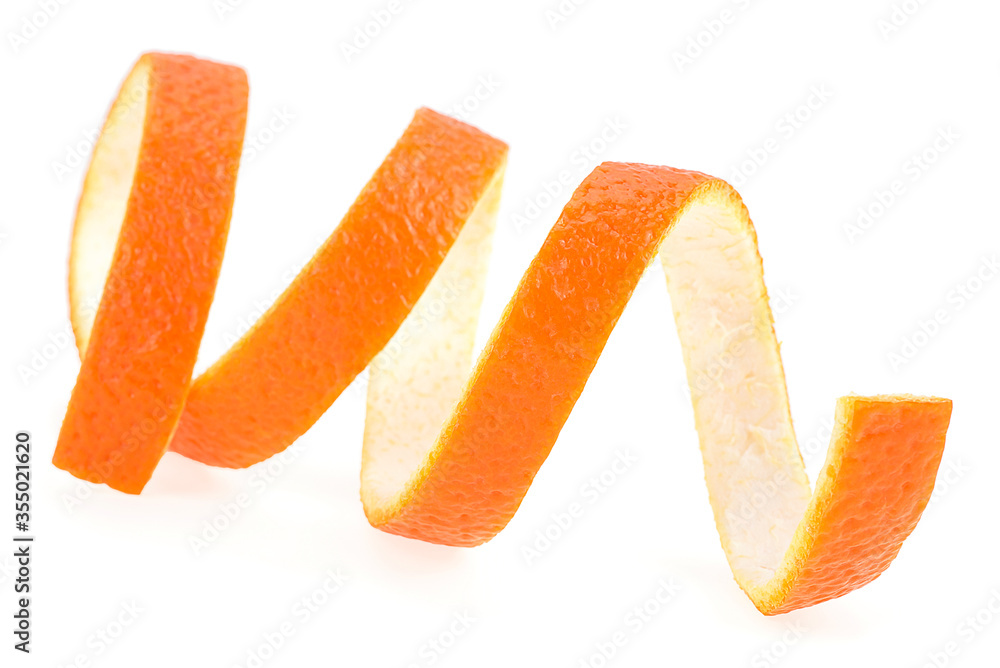 Spiral form of fresh orange skin isolated on a white background. Orange zest. Spiral form of fresh orange skin isolated on a white background. Orange zest.