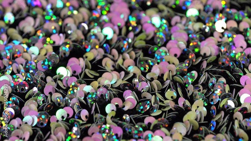 Festive brilliant multi-colored holographic pink metallic background. Fabric with sequins close up
