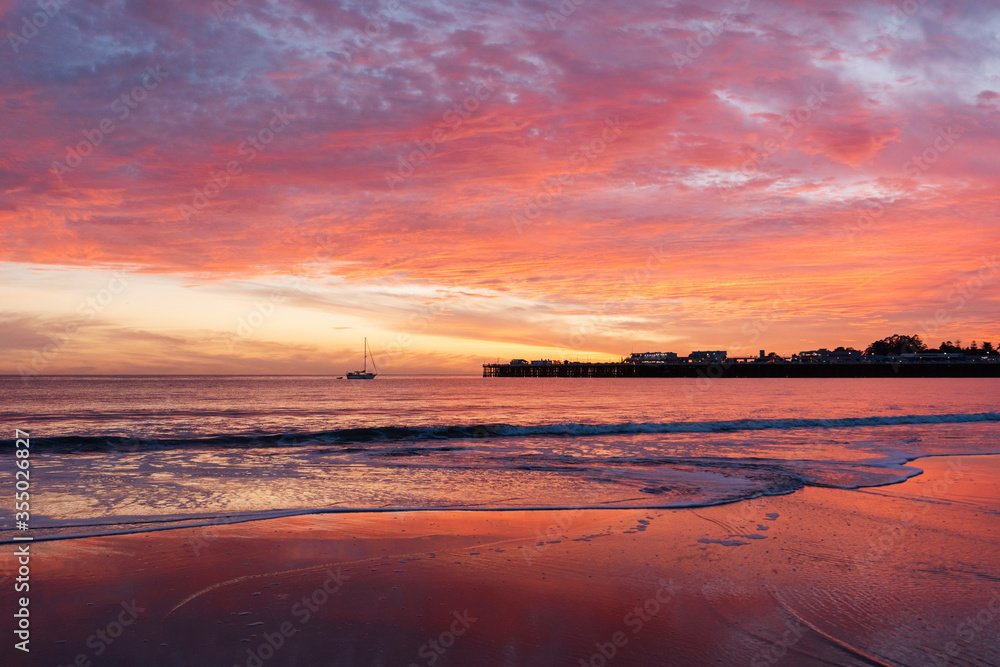 Incredible red sunset in Santa Cruz. Red sky on the beach in California
