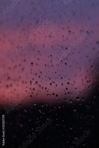 raindrops on window with sunset