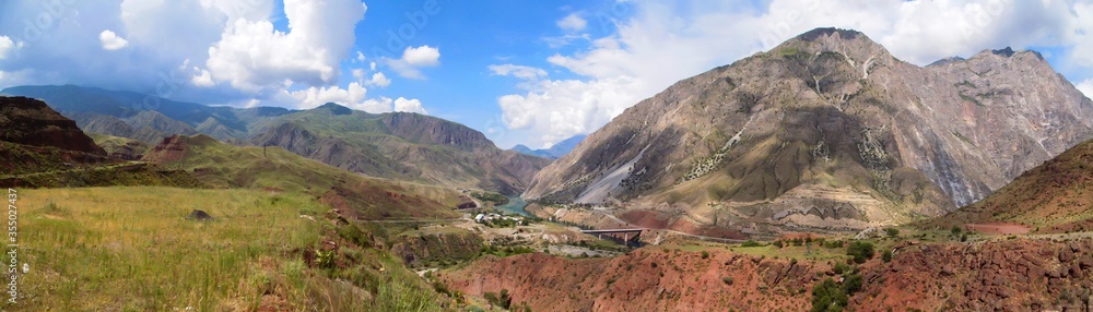 Naklejka premium Panorama of hills around Naryn river valley in central Kyrgyzstan. The road between north and south of this country extends for many kilometers parallel to the river