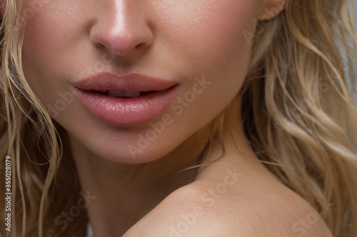 Close-up of woman's Lips with Fashion pink Make-up and Manicure on Nails. Beautiful female full lips with perfect Makeup. Part of female face. Macro shot of beautiful make up on full lips
