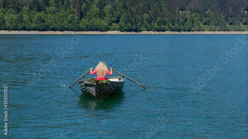 romantic scene with female model with long blond hair on a boat.