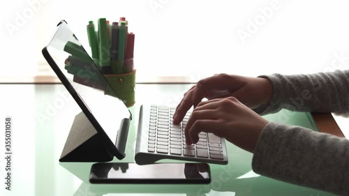 Little girl doing homework at home on the computer