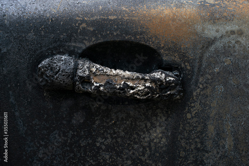 A burnt passenger car burned to the ground during a fire and strike. Fused plastic and metal auto parts photo