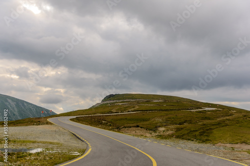 The road in the sky on a rainy cloudy summer day - Transalpina road in Romania - the highest mountain road in the Carpathians 