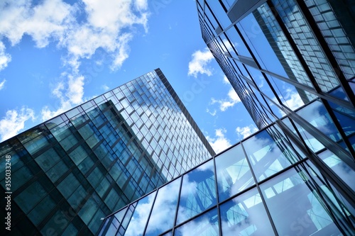 Facade texture of a glass mirrored office building. Fragment of the facade. Modern architecture of the office building.