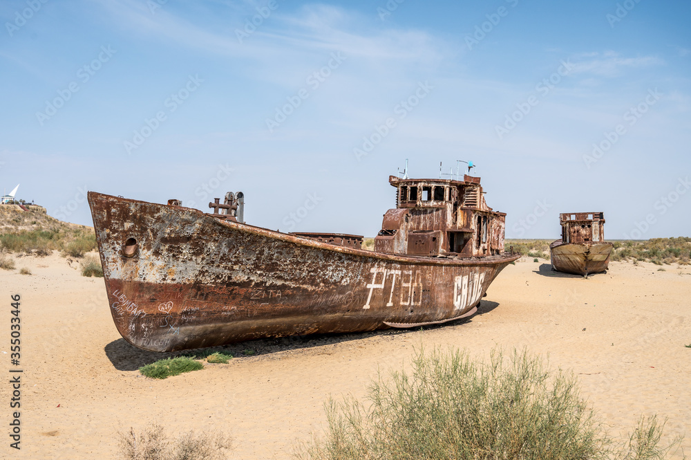 Moynaq, Uzbekistan 09 20 2019: Rusting shipwrecks on Aral Desert in former area of Aral sea harbor in village of Mo'ynaq, evidence of ecological cathastrophy