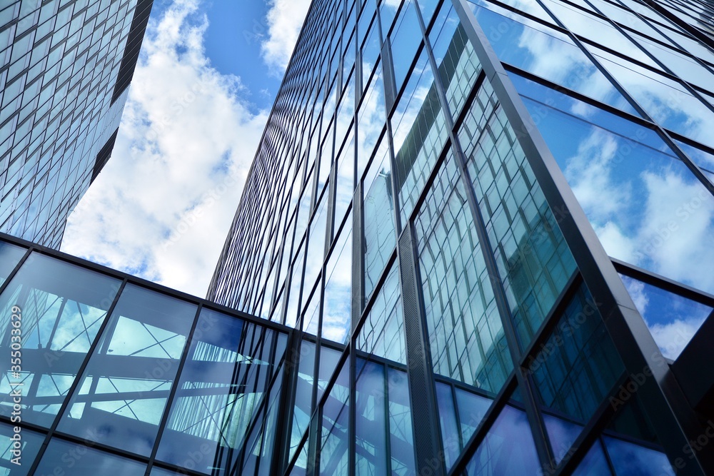 Facade texture of a glass mirrored office building. Fragment of the