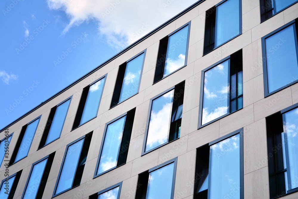 Facade texture of a glass mirrored office building. Fragment of the facade. Modern architecture of the office building. Facade texture of a glass mirrored office building. Fragment of the facade. Modern architecture of the office building.