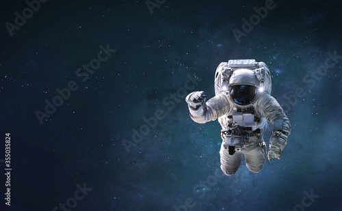 Fototapeta Naklejka Na Ścianę i Meble -  Astronaut on background with space and stars. Wallpaper for background. Elements of this image furnished by NASA