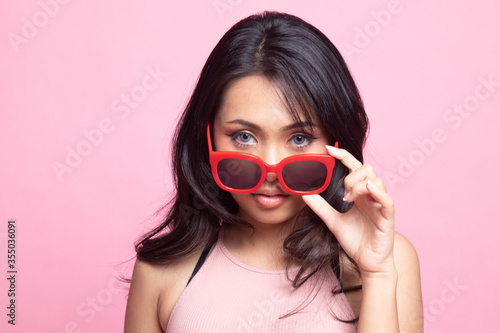 Portrait of a beautiful young asian girl in sunglasses.