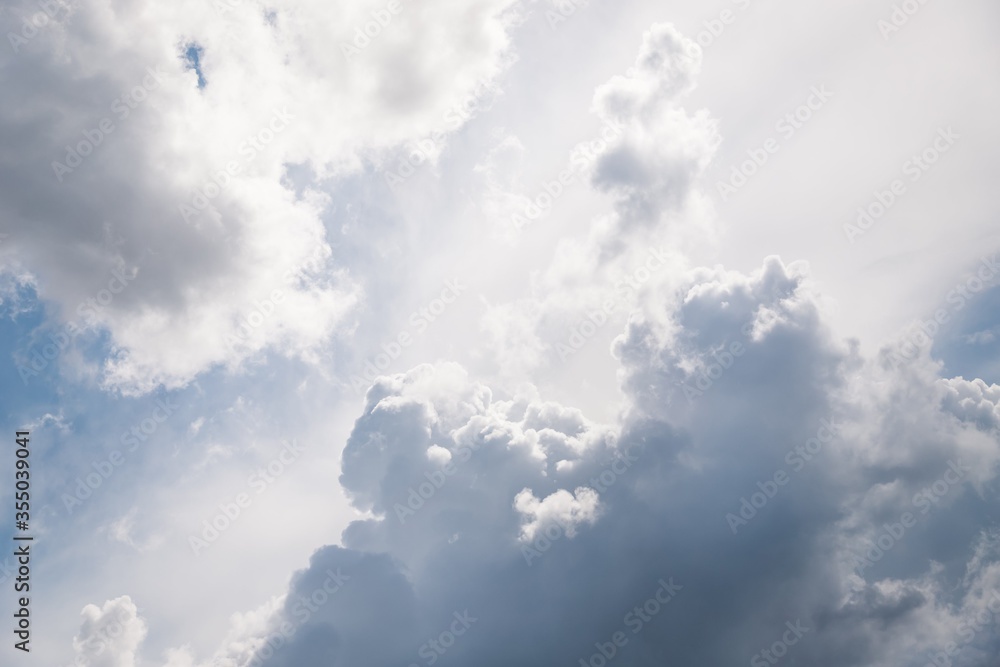 Gray and white fluffy clouds in the pale sky. Beautiful sky Gray and white fluffy clouds in the pale sky. Beautiful sky