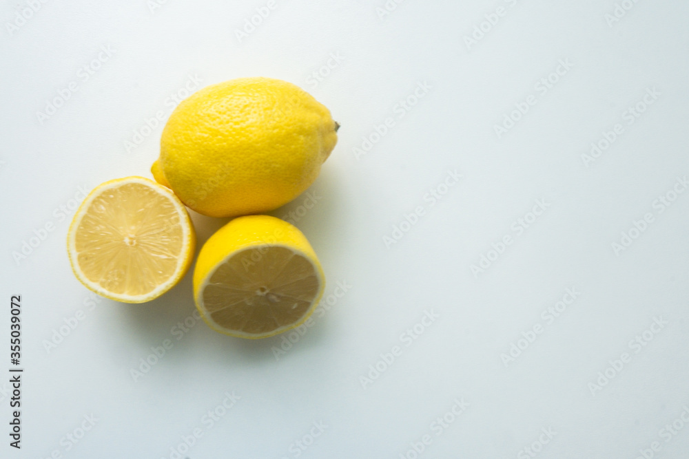 group of lemons isolated on a white table. cut lemon. view from above group of lemons isolated on a white table. cut lemon. view from above