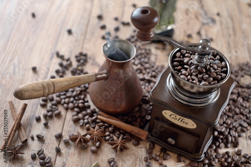  old vintage hand grinder with Coffee beans and spices on wooden table 