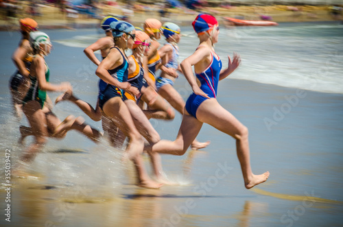 Nippers competitors running into the ocean in surf lifesaving beach swimming event, Australia
