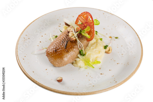 Grilled duck breast with mashed potato garnish. Isolated on a white background.