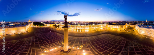 Aerial panoramic view to Winter Palace building and Square in summer white night. Angel on Aleksandr Column is symbol peace on Europe. Top view from drone with cloudy background, St. Petersburg Russia photo