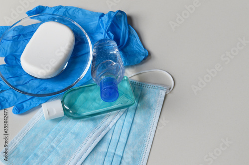 Covid-19 prevention concept background, rubber gloves, hand sanitizer, surgical masks and antibacterial soap isolated on white background, medical backdrop