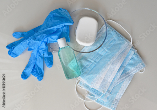 Covid-19 prevention concept background, rubber gloves, hand sanitizer, surgical masks and antibacterial soap isolated on white background, medical backdrop