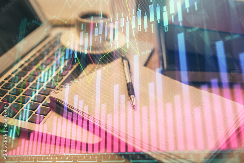 Double exposure of forex chart drawing and desktop with coffee and items on table background. Concept of financial market trading Double exposure of forex chart drawing and desktop with coffee and items on table background. Concept of financial market trading