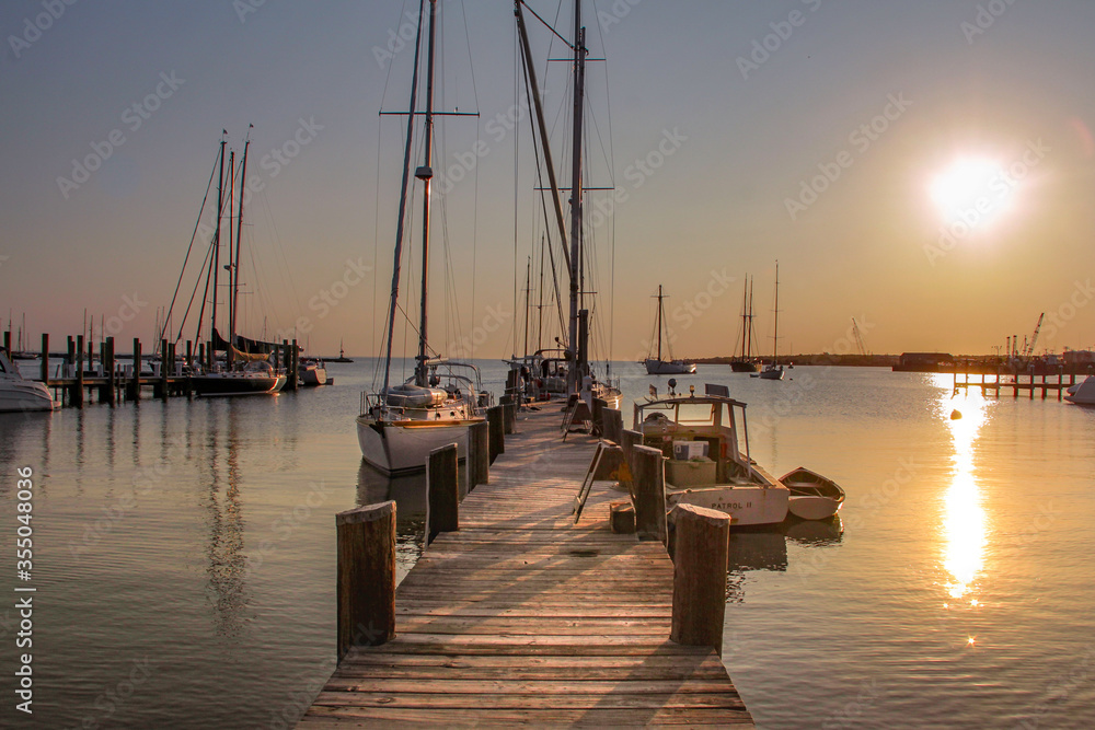 Marthas Vineyard, MA / United States-May 29, 2016: Sail boat and motor boat tied to the dock Martha's Vineyard