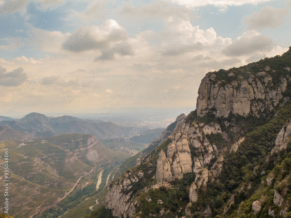 Naklejka premium Montserrat, Barcelona / Spain - Sept. 8, 2016: The dramatic mountain of Montserrat, famous for its wind-sculpted rock formations and Benedictine abbey,