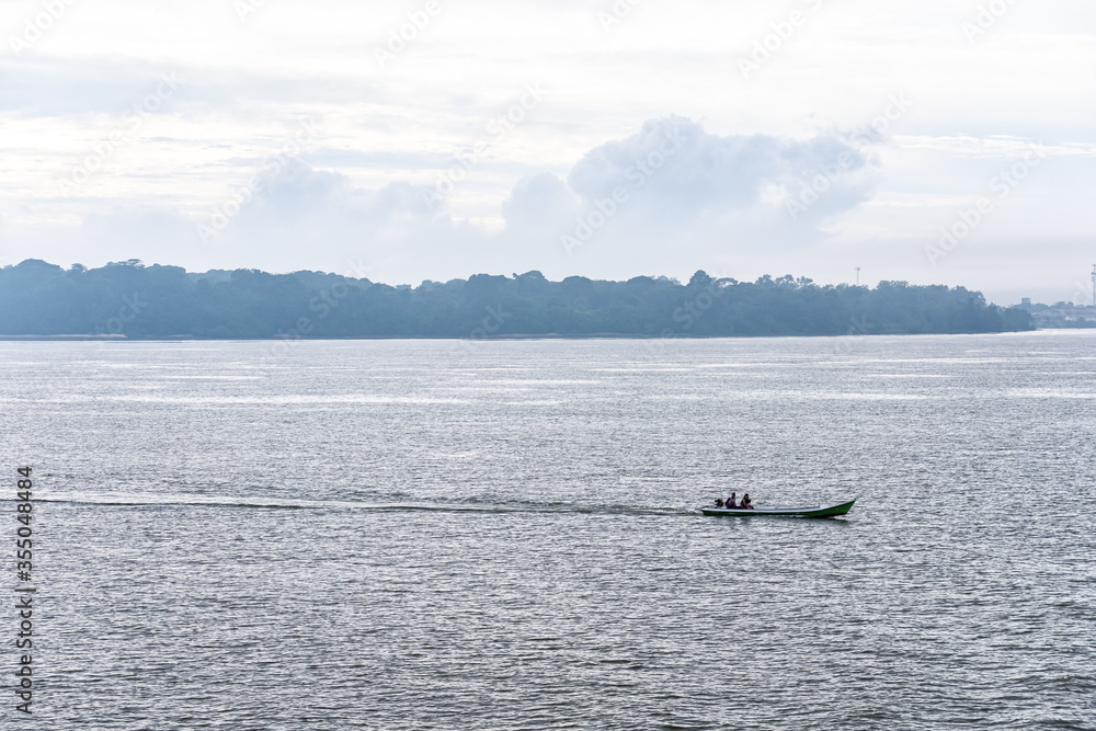 Fisherman Boat On A River in Amazon Rainforest Region
