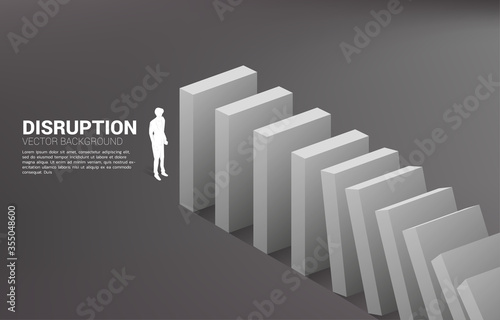 Silhouette of businessman standing at the end of domino collapse. Concept of business industry disrupt
