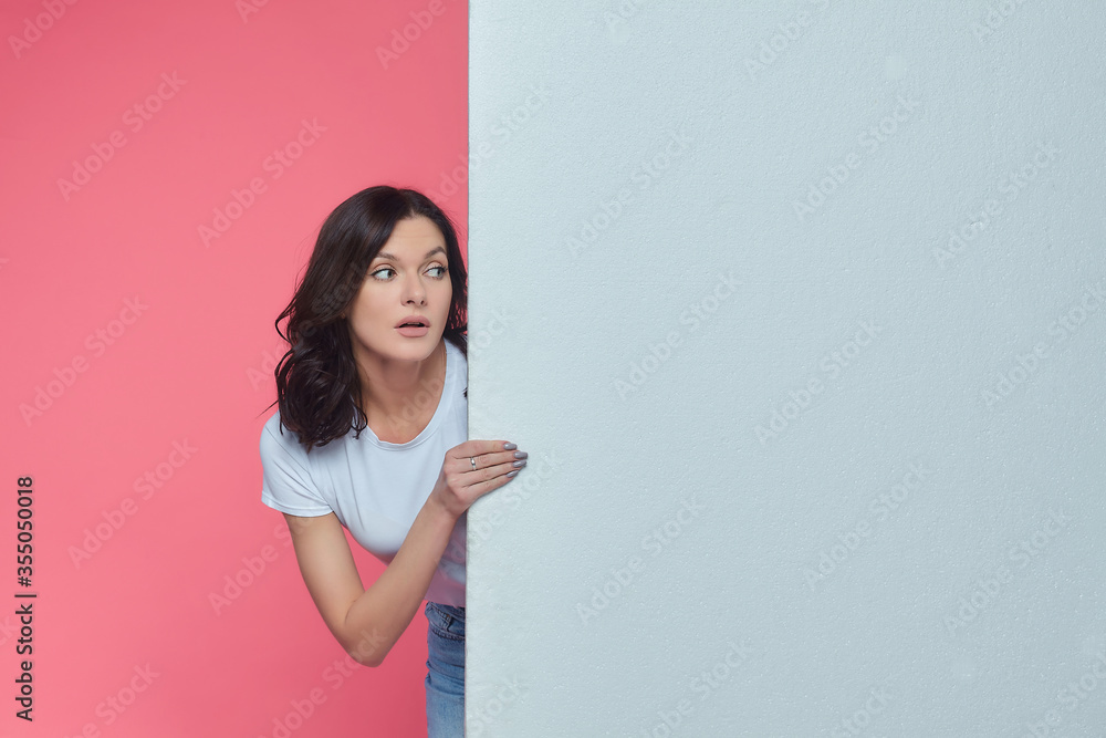 beautiful girl gestures to an empty space for the text. Presentation of your product. the concept of advertising beautiful girl gestures to an empty space for the text. Presentation of your product. the concept of advertising