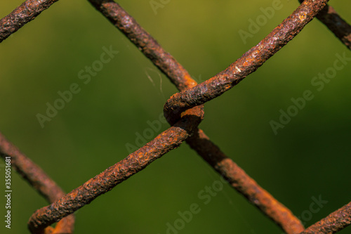 Rusted metal fance weave close up