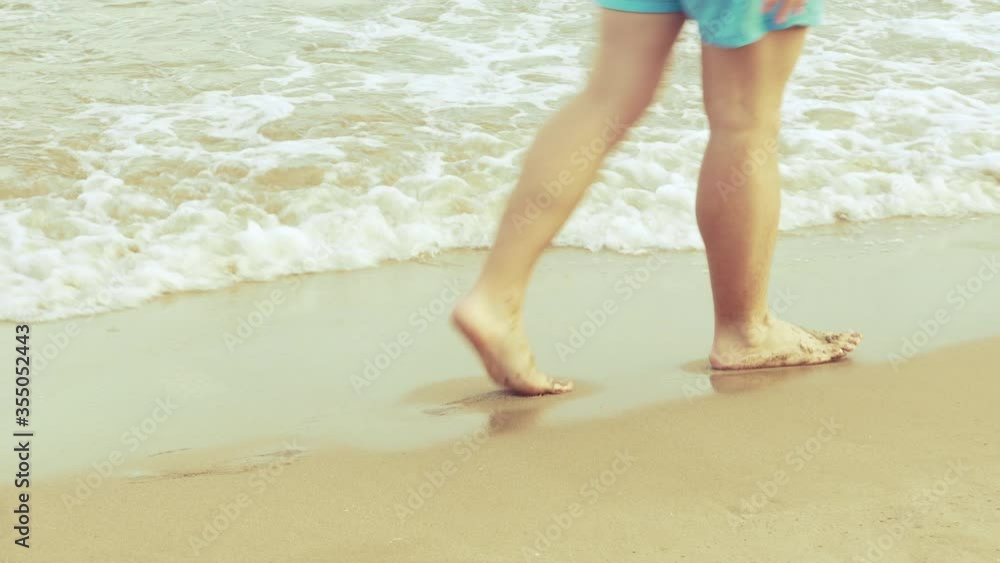 Male Walking and Leaving Footprints on Sand Male Walking and Leaving Footprints on Sand