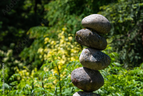 Photography Stacked rocks in a garden, meditation focus for wellness
