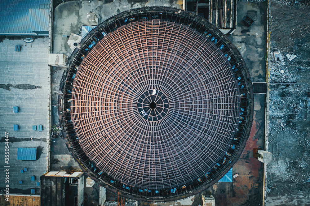 Obraz premium Above round iron roof of unfinished nuclear power plant, circle metal construction, industrial building, aerial top view.