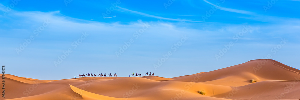 Merzouga in the Sahara Desert in Morocco. Web banner in panoramic view.