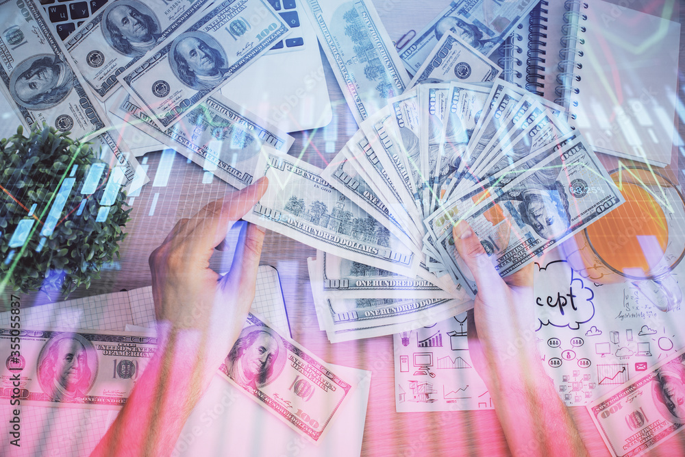 Multi exposure of financial graph drawing hologram and USA dollars bills and man hands. Analysis concept. Multi exposure of financial graph drawing hologram and USA dollars bills and man hands. Analysis concept.