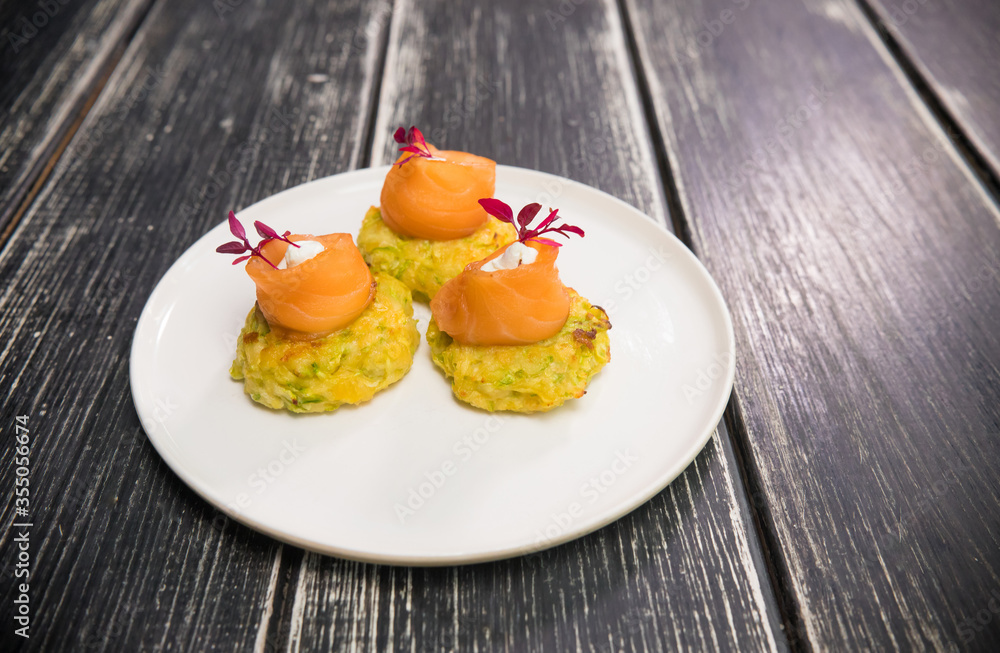 Light small portion of snack with red fish on the plate Light small portion of snack with red fish on the plate