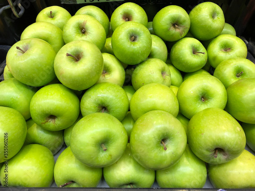 Background of fresh green apples on sale at the local market