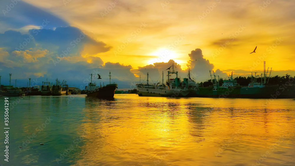 The boat is parked on the river in the evening, the sunset and sunrise at Mahachai in Samut Sakhon The boat is parked on the river in the evening, the sunset and sunrise at Mahachai in Samut Sakhon