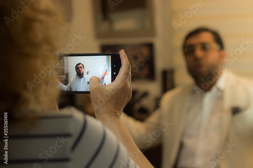 Woman recording a man with a cell phone