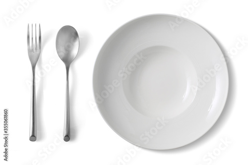 A white plate with a silver fork and spoon on a white background