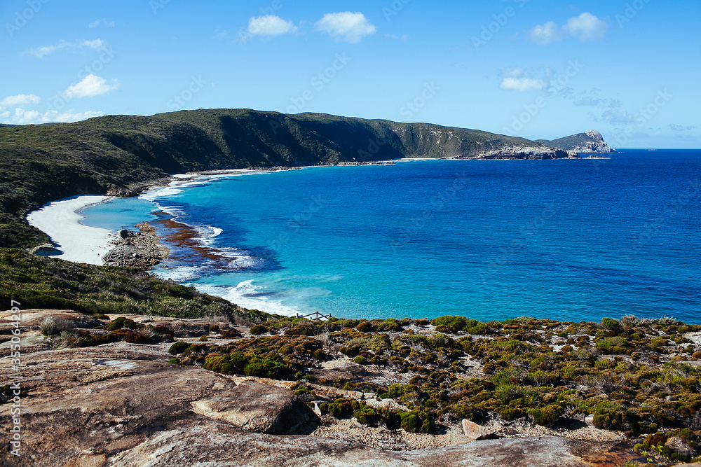 Beautiful view of cliff coast and Cable Beach at Torndirrup National Park, Albany beach, Western Australia, Wild Southern Ocean, blue sky on sunny day. Selective focus.