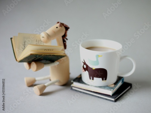 cup of coffee and reading donkey figurine for morning and book wallpaper