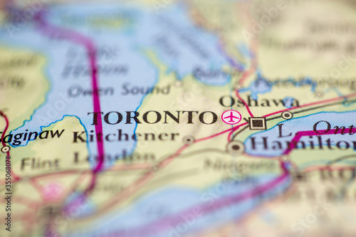 Shallow depth of field focus on geographical map location of Toronto city Canada America continent on atlas