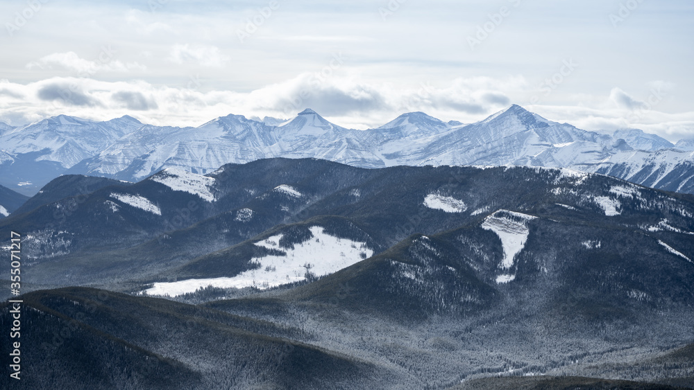 Snowy mountain ranges during winter, shot at Prairie Mountain summit, Kananaskis, Alberta, Canada 